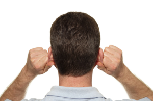Backshot of a man holding his ears